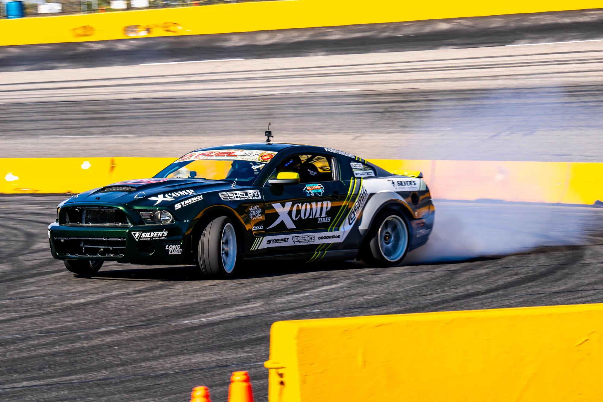 Jonathan Nerren's gray-and-green XComp S197 Mustang drifting through tire smoke